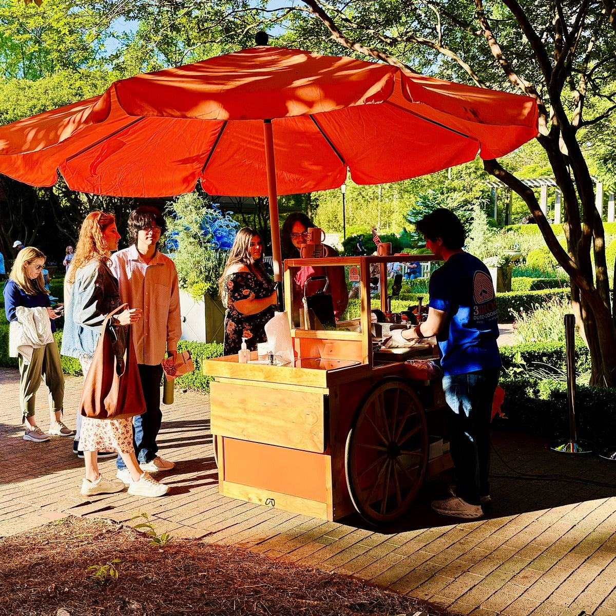 3 Bros stroopwafel baking cart set up at an outdoor market