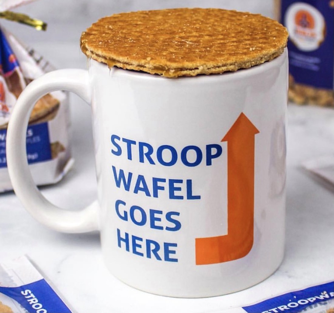 A fresh stroopwafel warming on top of a mug of coffee